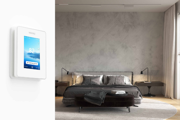 modern grey bedroom with 6iE thermostat on wall