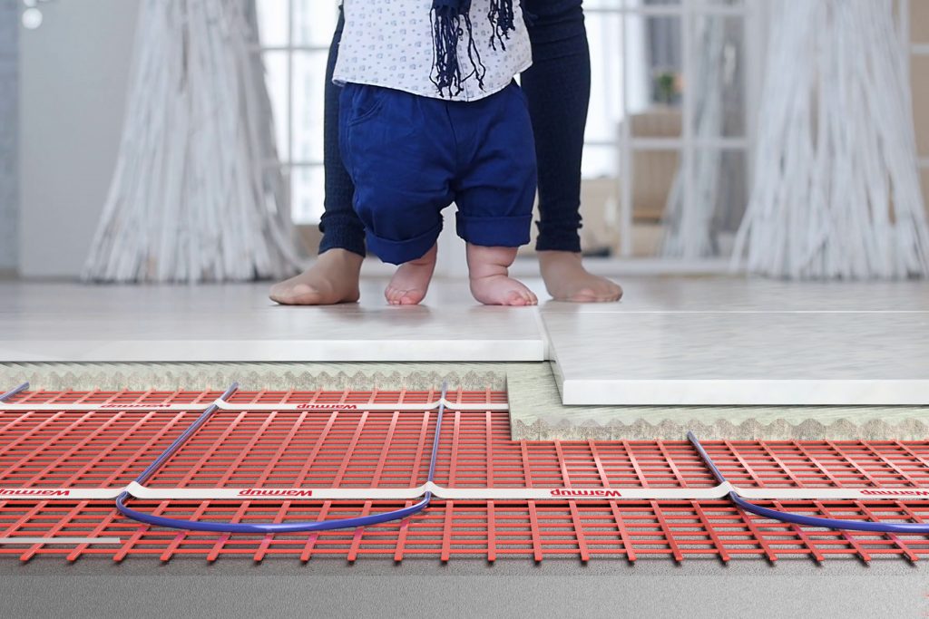 pieds de bébé sur le sol chauffant Sticky Mat