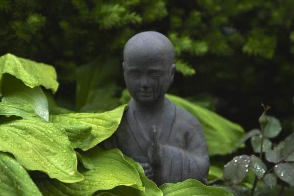 garden statue surrounded by leaves