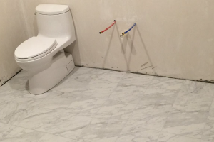 Should You Tile Under Or Around The Toilet When Installing Heated Floors ?