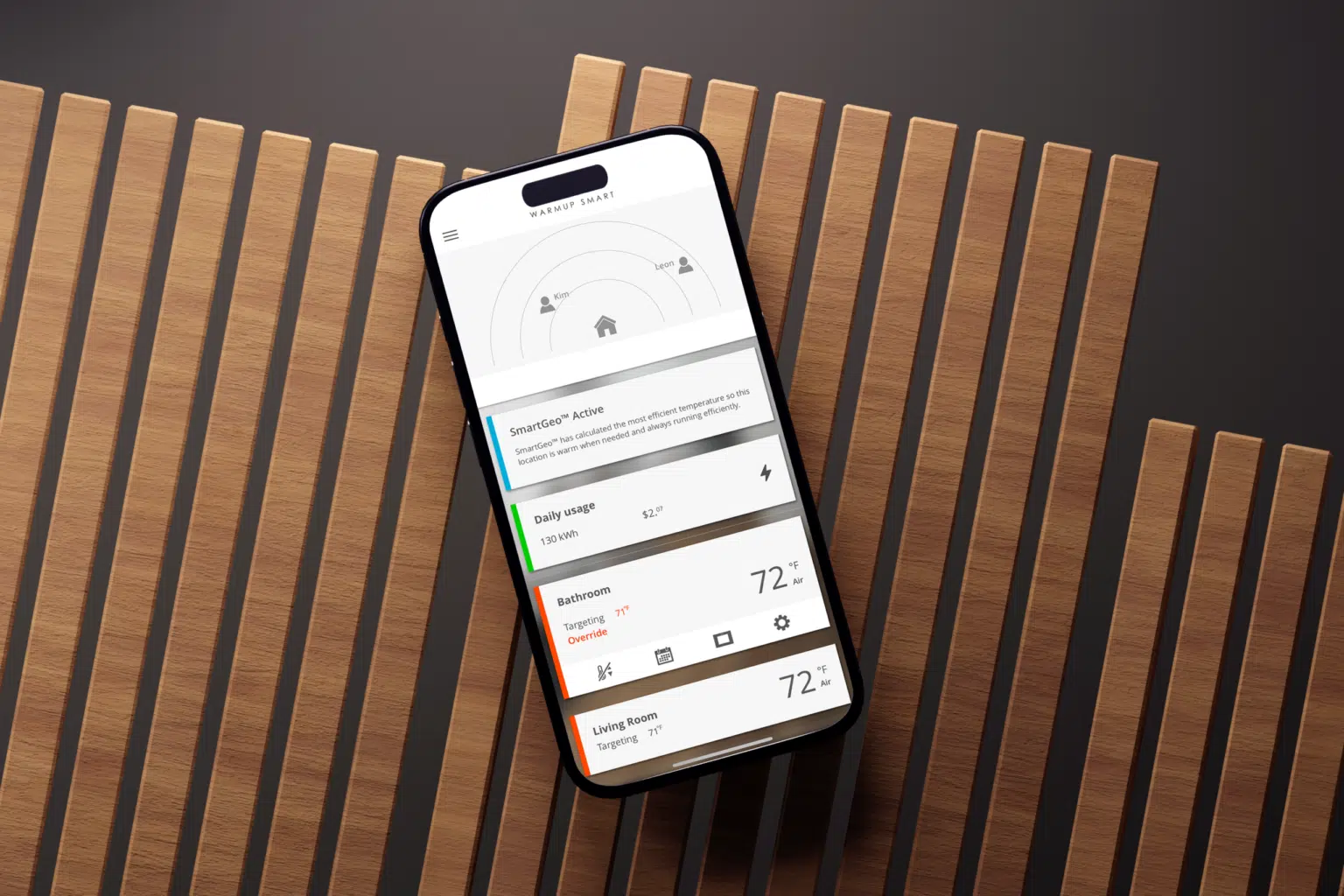 An iPhone running Warmup's MyHeating app for underfloor heating.