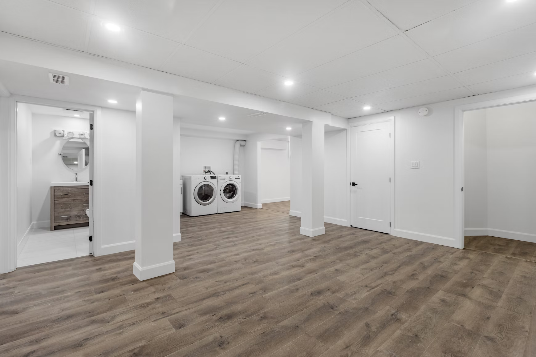 a newly renovated basement with vinyl plank floors