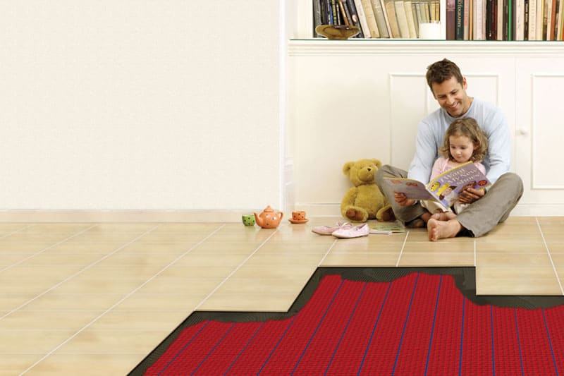 Family sitting on a floor with underfloor heating.