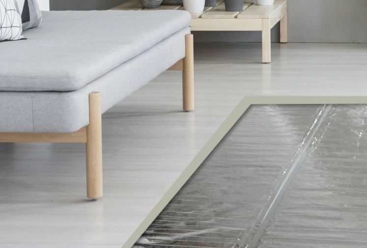 A cutaway image showing Warmup's Foil Mat radiant heat product under a floating floor.