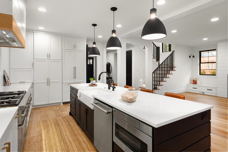 white kitchen with dark accent in new farmhouse