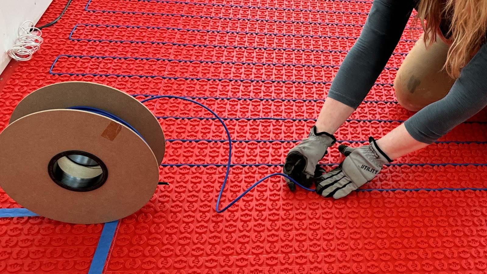 Warmup's DCM-PRO Cable being installed in membrane.