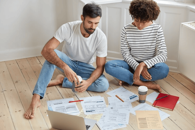 Homeowners reviewing rebates for underfloor heating.