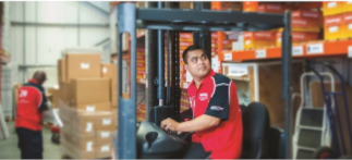 An employee using a forklift in a warehouse