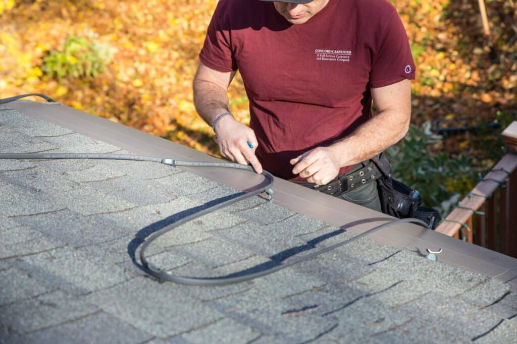 outdoor heating self-regulating cables being installed on a single roof.