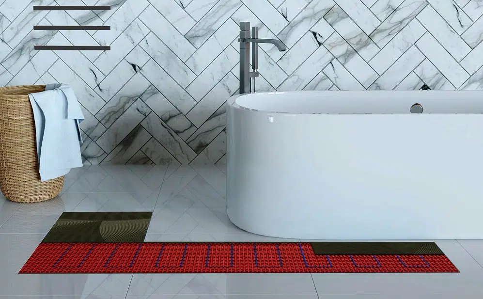 A white tiled bathroom with Warmup's DCM-PRO Underfloor Heating System installed under the floor tile.